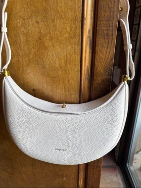 Songmont White Pebbled Crescent Shoulder Bag with Gold Accents